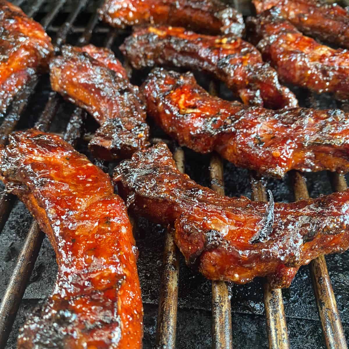 Individual Ribs, Glazed and resting on a grill grate
