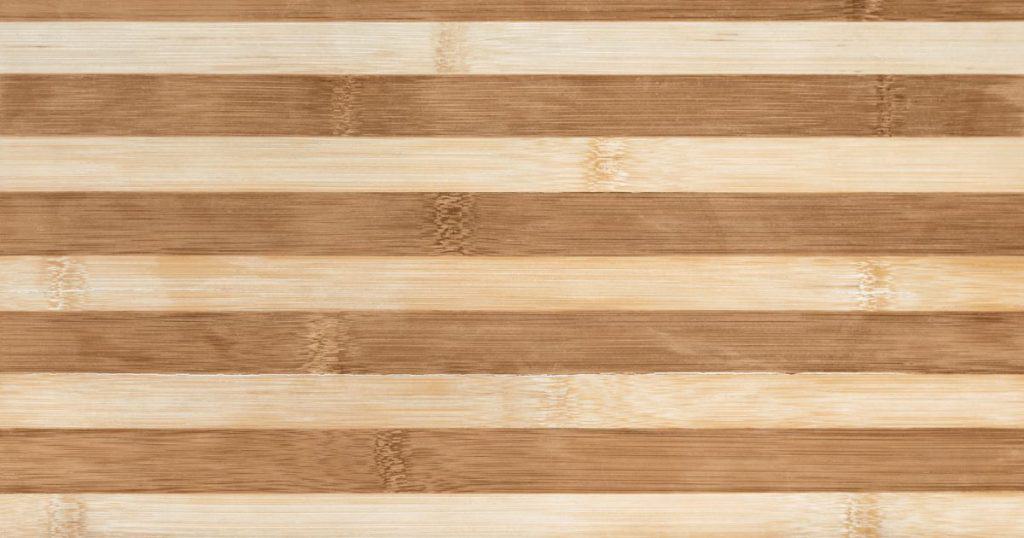 white and light brown edge grain wood cutting board