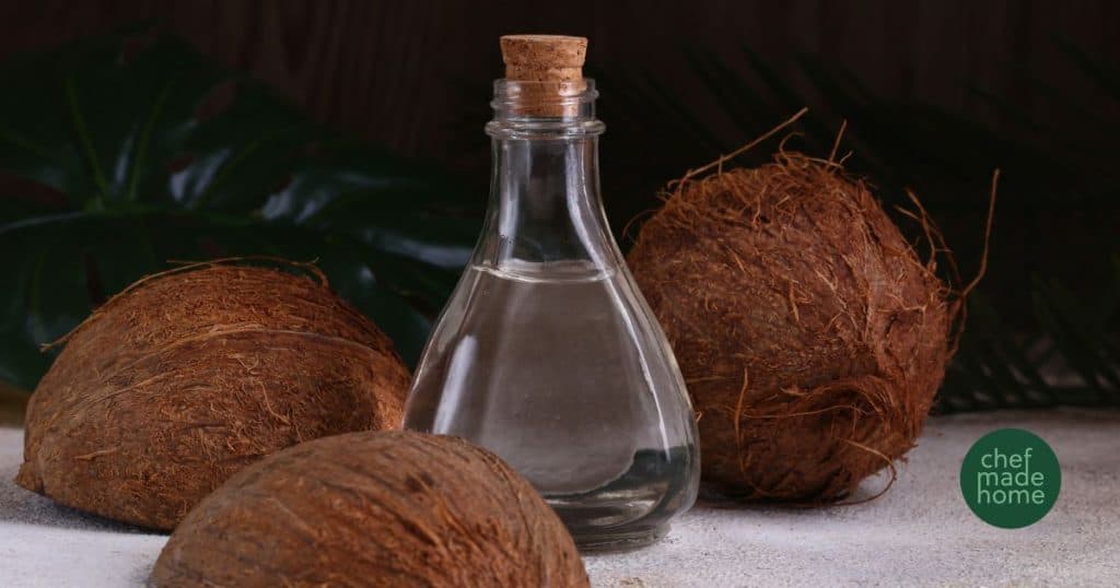 Coconut Oil with coconut halves around it