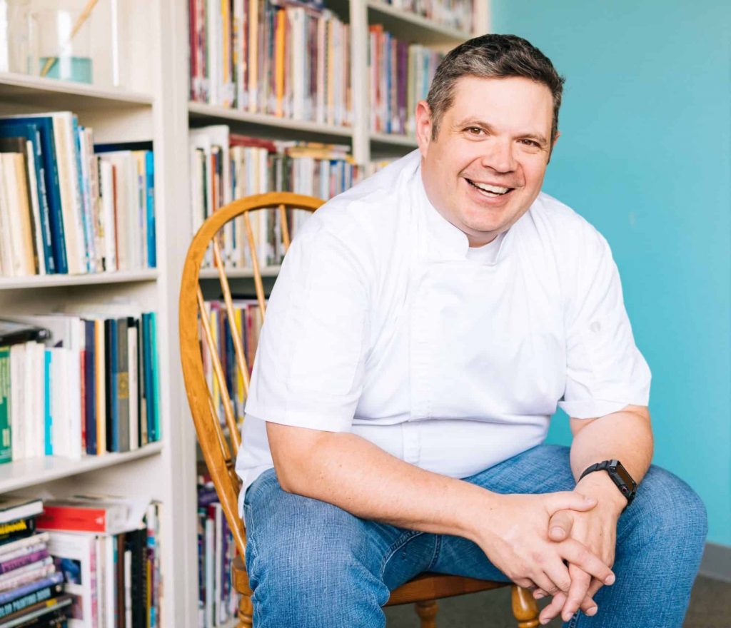 Chef Sitting in Front of Books